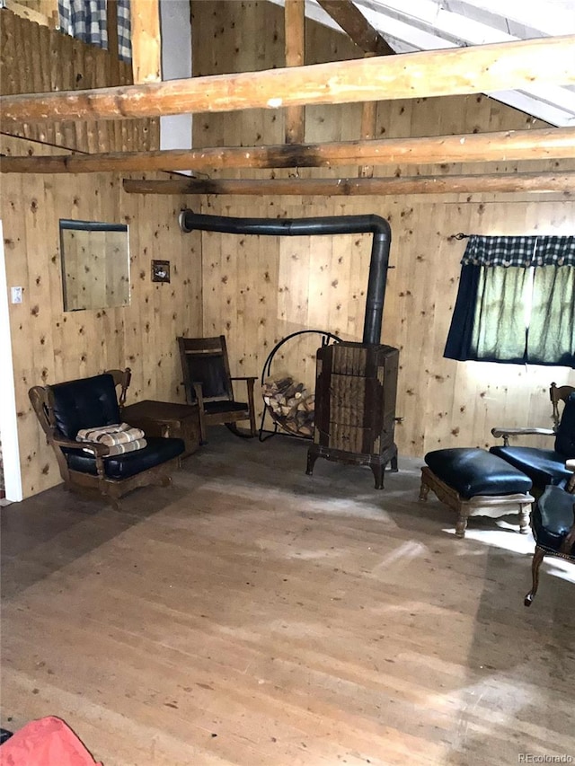 10504 Jackson Creek Rd, Sedalia, CO 80135 - sitting room with wood finished floors, a wood stove, and wooden walls
