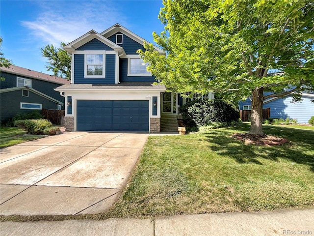5005 W 128th Pl, Broomfield, CO 80020 - view of front of home with stone siding, a front lawn, a garage, and concrete driveway