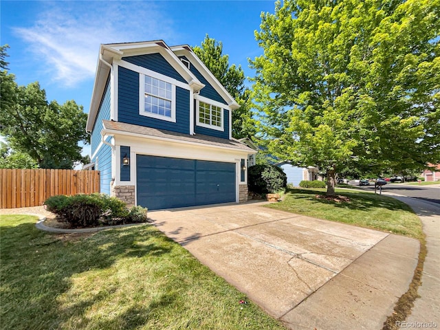 5005 W 128th Pl, Broomfield, CO 80020 - view of front of home featuring a garage, driveway, and stone siding