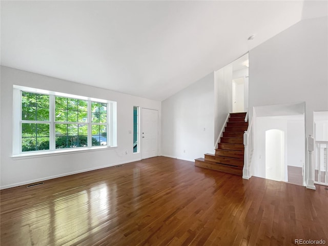 5005 W 128th Pl, Broomfield, CO 80020 - unfurnished living room with lofted ceiling, hardwood / wood-style floors, and stairway