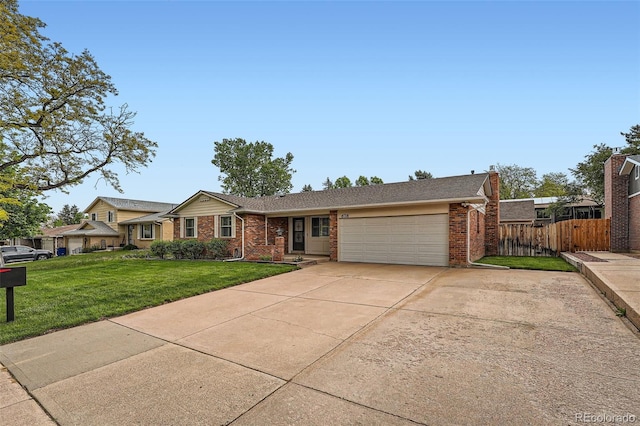 678 S Oswego Ct, Aurora, CO 80012 - view of front facade featuring an attached garage, driveway, and brick siding