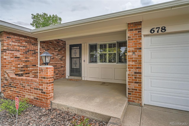678 S Oswego Ct, Aurora, CO 80012 - property entrance featuring brick siding, a porch, and board and batten siding