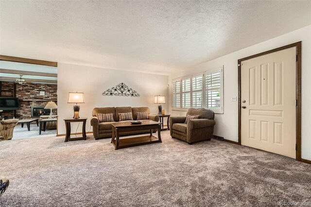 678 S Oswego Ct, Aurora, CO 80012 - carpeted living area with a textured ceiling, baseboards, and a brick fireplace