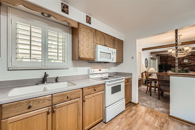 678 S Oswego Ct, Aurora, CO 80012 - kitchen featuring white appliances, a sink, light wood finished floors, light countertops, and pendant lighting