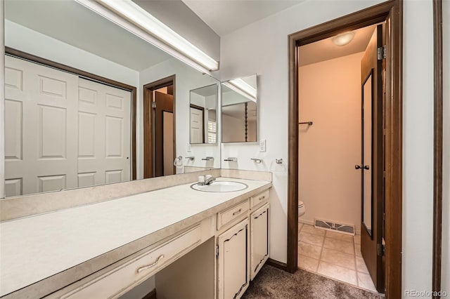 678 S Oswego Ct, Aurora, CO 80012 - bathroom featuring vanity, toilet, tile patterned flooring, and baseboards