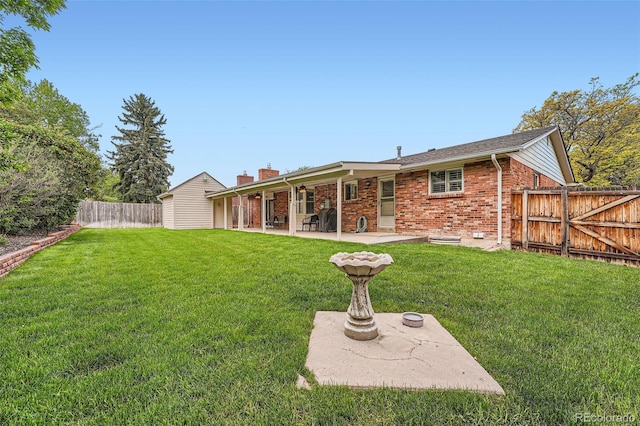 678 S Oswego Ct, Aurora, CO 80012 - rear view of house with a patio area, brick siding, and a chimney