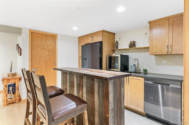 kitchen with sink, appliances with stainless steel finishes, and wooden counters