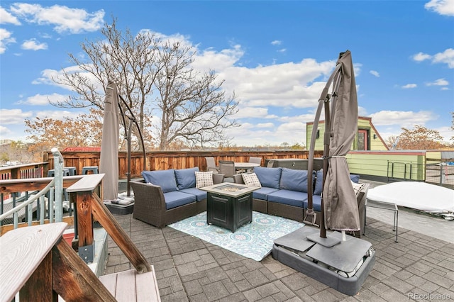 view of patio / terrace featuring an outdoor living space with a fire pit