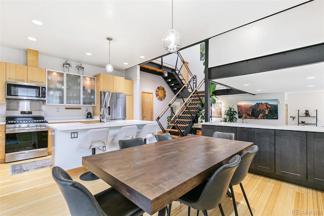 dining area featuring sink and light hardwood / wood-style floors