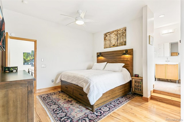 bedroom featuring ceiling fan, access to exterior, light wood-type flooring, and sink