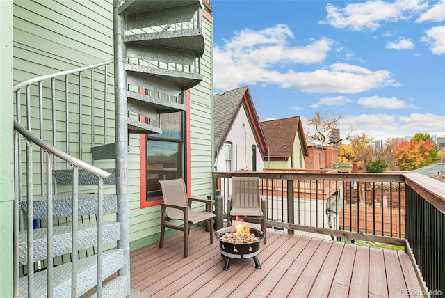 wooden deck featuring an outdoor fire pit