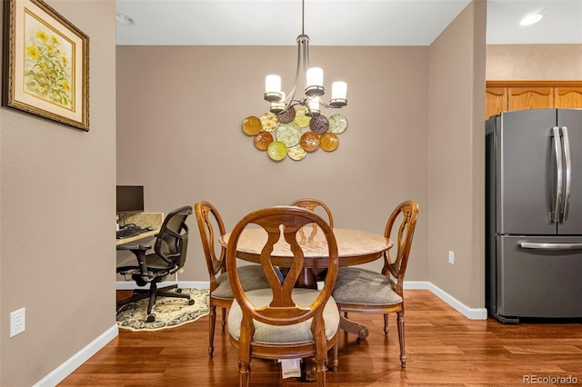 9390 W Chatfield Pl Unit 104, Littleton, CO 80128 - dining room with a notable chandelier, baseboards, and wood finished floors