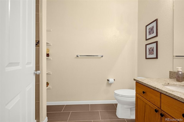 9390 W Chatfield Pl Unit 104, Littleton, CO 80128 - bathroom featuring vanity, toilet, baseboards, and tile patterned floors