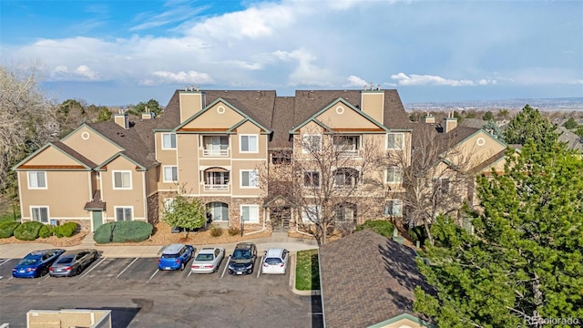 9390 W Chatfield Pl Unit 104, Littleton, CO 80128 - view of building exterior featuring uncovered parking