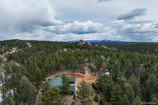 drone / aerial view with a wooded view