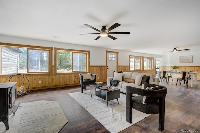 living room featuring wainscoting, a ceiling fan, wood finished floors, and visible vents