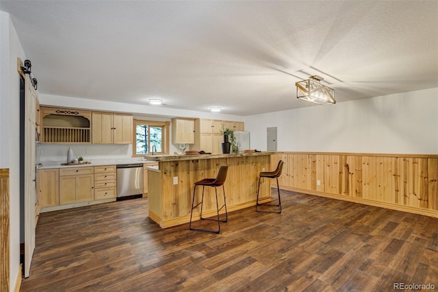 kitchen with a kitchen island, dishwasher, freestanding refrigerator, light brown cabinets, and dark wood-type flooring