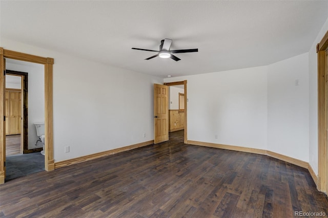 empty room with a ceiling fan, baseboards, and dark wood-type flooring