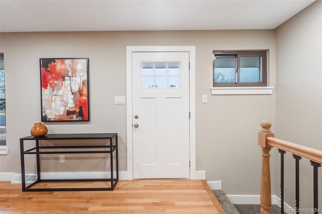 entrance foyer featuring light wood-style floors and baseboards