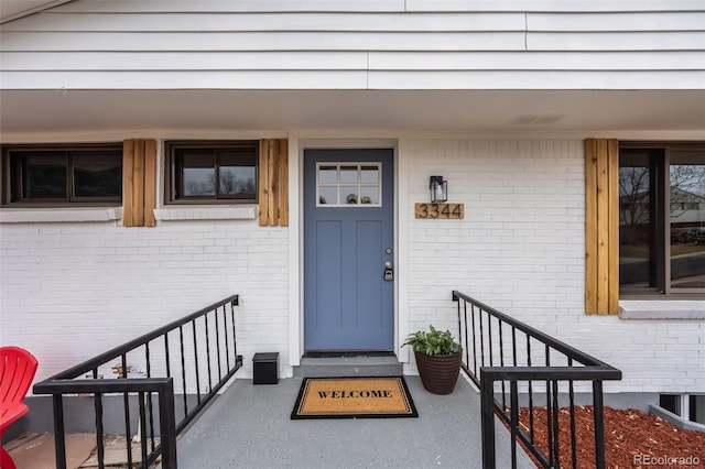 property entrance featuring brick siding