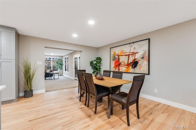 dining area with recessed lighting, baseboards, and light wood finished floors