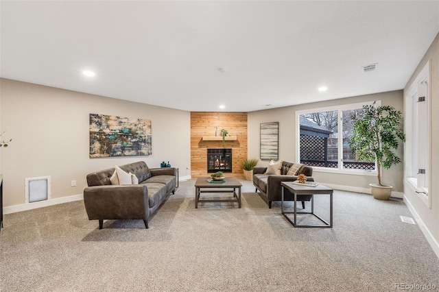 living area with recessed lighting, light colored carpet, visible vents, baseboards, and a lit fireplace