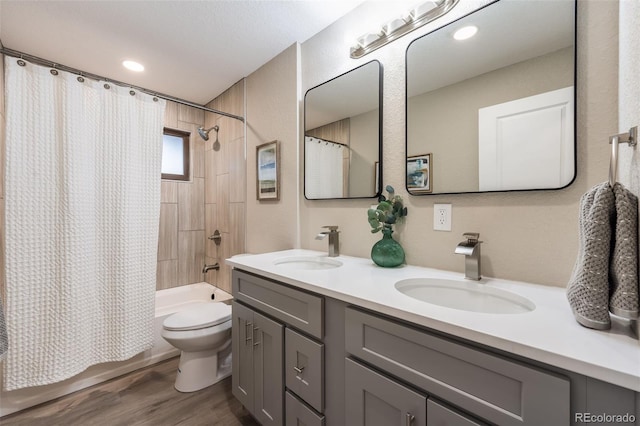 bathroom with shower / bath combination with curtain, a sink, toilet, and double vanity