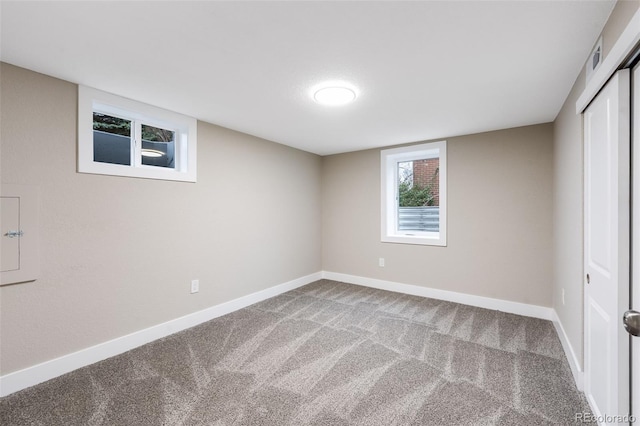 interior space with carpet and baseboards