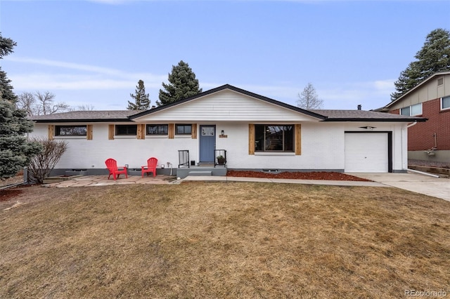 single story home with concrete driveway, brick siding, an attached garage, and a front lawn