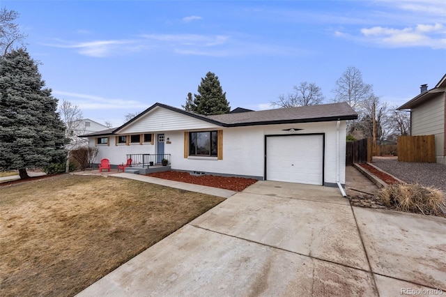 ranch-style home with an attached garage, brick siding, fence, driveway, and a front lawn