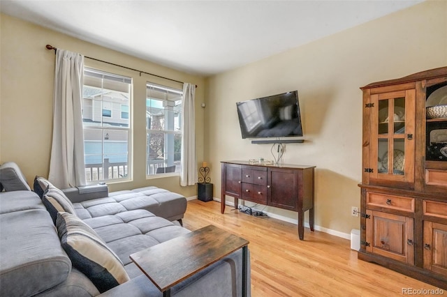 living room featuring light wood finished floors and baseboards