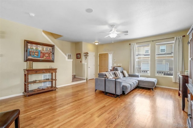 bedroom with baseboards, light wood finished floors, and a ceiling fan