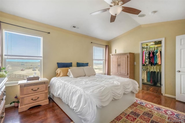 bedroom featuring dark wood-type flooring, visible vents, multiple windows, and lofted ceiling
