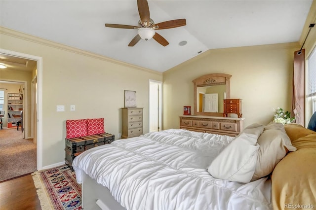 bedroom with wood finished floors, multiple windows, ornamental molding, and lofted ceiling