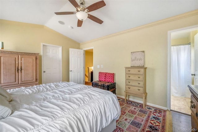 bedroom featuring baseboards, a ceiling fan, and vaulted ceiling