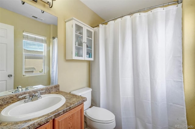 full bathroom featuring vanity, visible vents, and toilet