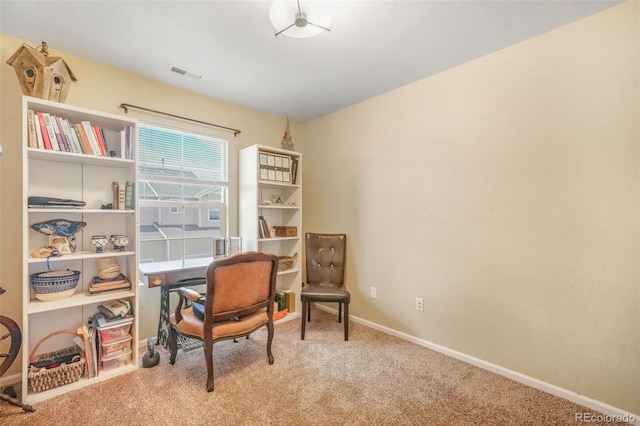 living area with baseboards, visible vents, and carpet floors