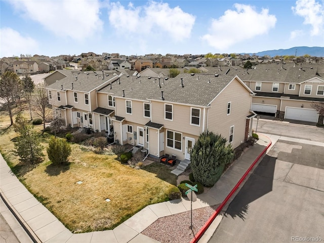 birds eye view of property with a mountain view and a residential view