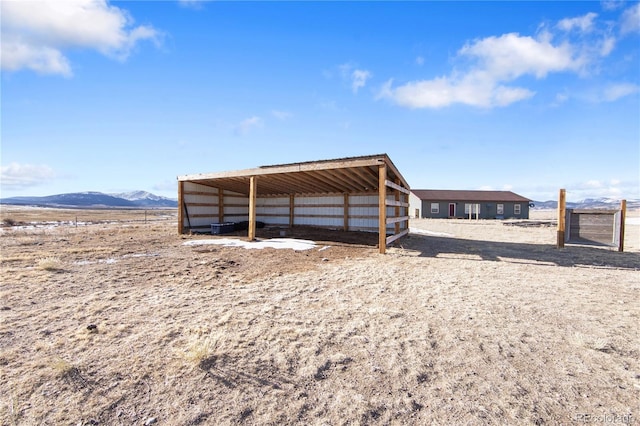 view of outbuilding with a mountain view and a rural view