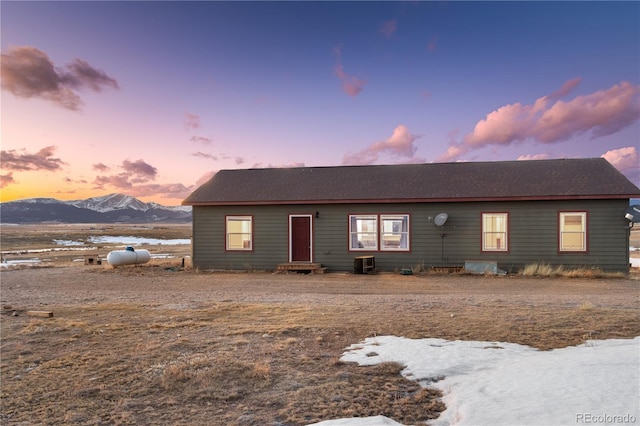 view of front facade with central AC unit and a mountain view