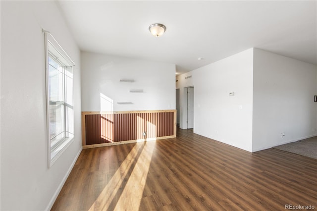 unfurnished room featuring dark wood-type flooring