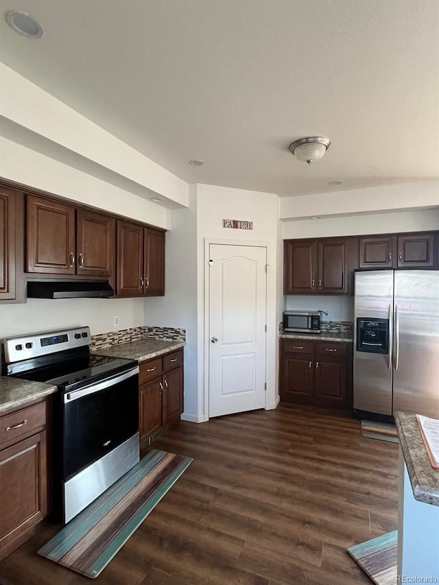 kitchen with dark hardwood / wood-style flooring, dark brown cabinets, and appliances with stainless steel finishes