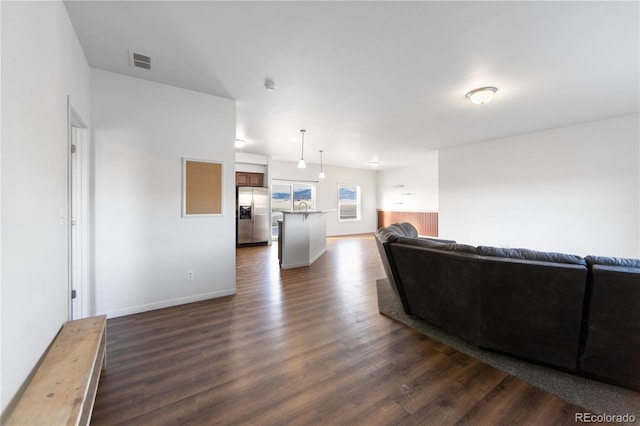 living room with dark hardwood / wood-style flooring and sink