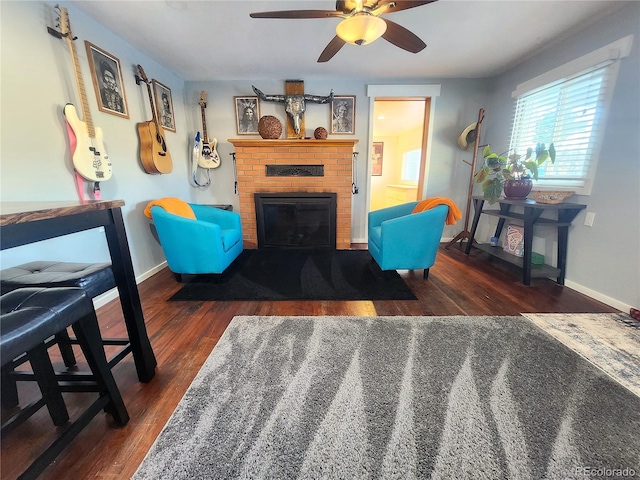 living room with ceiling fan, dark hardwood / wood-style flooring, and a fireplace