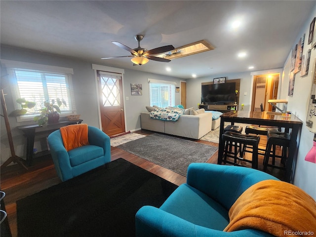 living room featuring ceiling fan and wood-type flooring