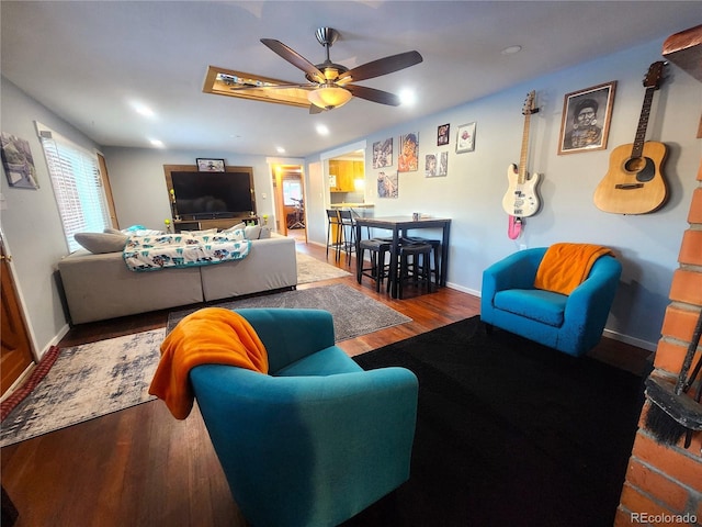 living room featuring ceiling fan and hardwood / wood-style flooring