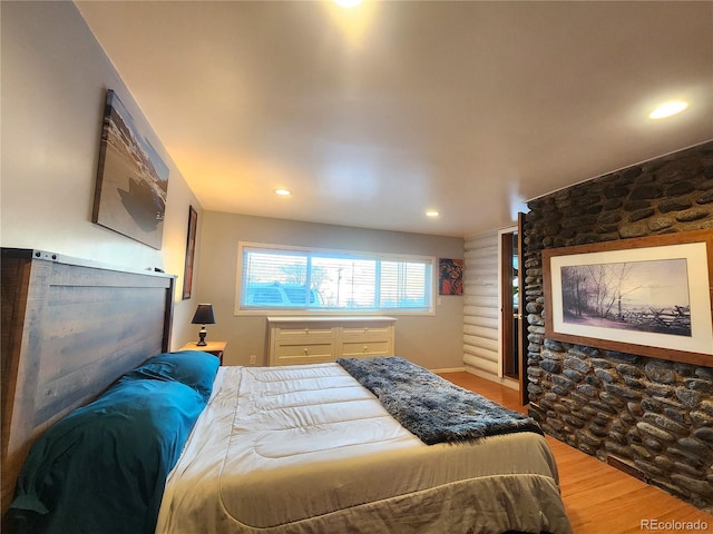 bedroom with hardwood / wood-style flooring