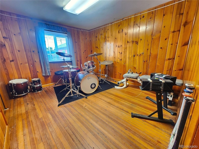 interior space with wood-type flooring and wooden walls