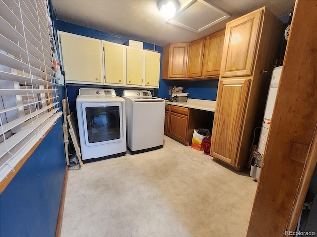 laundry room featuring separate washer and dryer, cabinets, and gas water heater