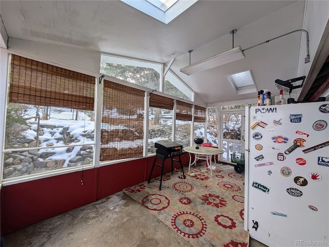 sunroom / solarium with vaulted ceiling with skylight